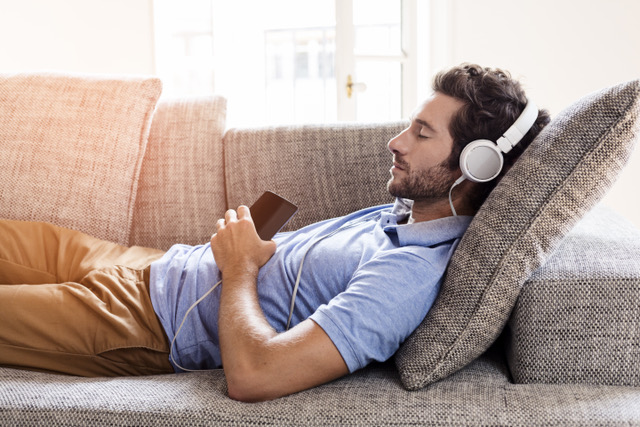 man listening to music on the couch